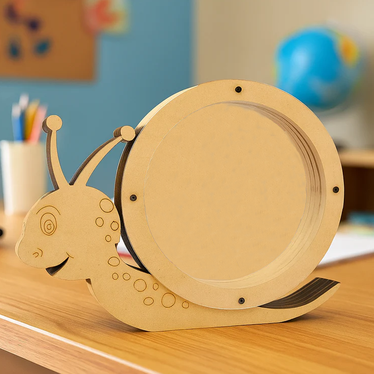 DIY MDF snail-shaped Money Bank on a wooden surface with a colorful background