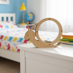 Plain MDF snail coin bank on bed with hand inserting coin.