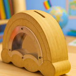 DIY MDF Rainbow shaped money bank with a rainbow inside, set against a colorful background.
