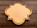 Medium quatrefoil MDF platter on dark wooden background.