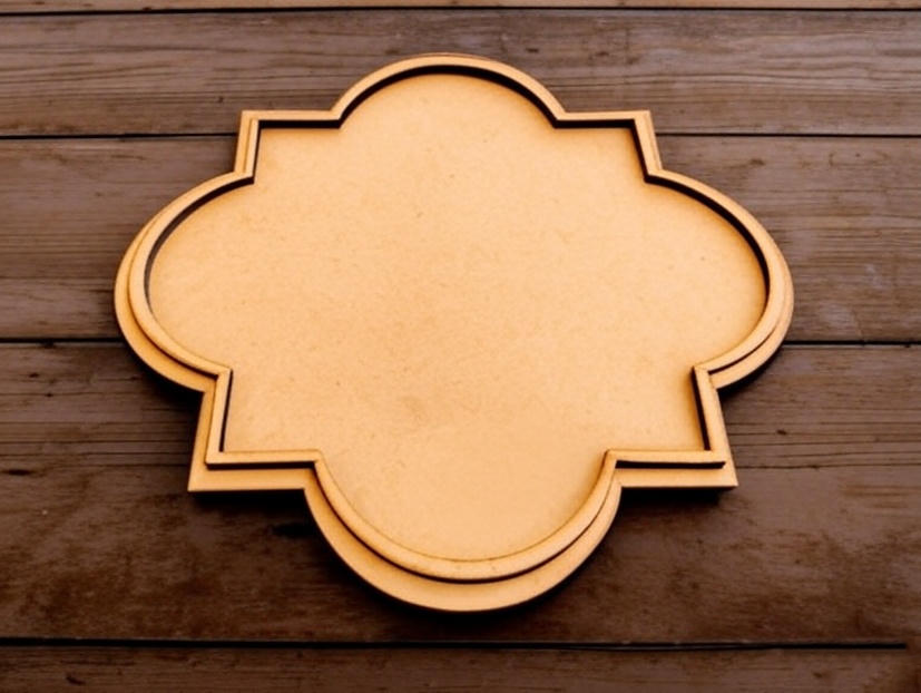 Medium quatrefoil MDF platter on dark wooden background.