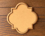 quatrefoil MDF platter on wooden floor.
