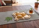 MDF quatrefoil tray serving puff pastries with mint tea in glass cup on rustic table