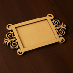 Rectangular MDF platter with ornate cutwork handles placed flat on wooden surface.
