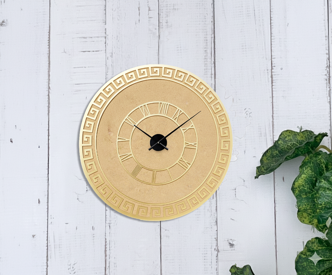 Gold decorative wall clock on a white wooden background with green leaves.