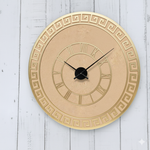 Decorative DIY wall clock with Roman numeral design on a light wooden background