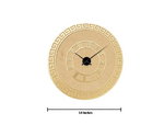 Gold wall clock with Roman numeral markers on a white background