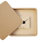 Decorative Shadow wall clock with a beige frame and open lid on a white background