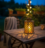 MDF lattice lantern glowing on outdoor table at night.