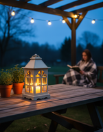 Decorative MDF candle holder on outdoor picnic table at night