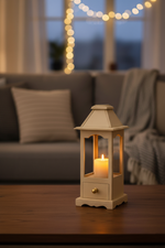 Lantern decor with lit candle in cozy holiday living room.