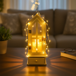 Decorative lantern with string lights on a table in a cozy living room setting.
