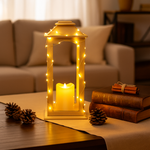 Decorative lantern with a lit candle on a table in a cozy living room setting.