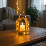 Decorative lantern with a lit candle on a wooden table in a cozy living room.