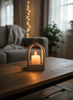 Candle in a lantern on a wooden table with a cozy living room background