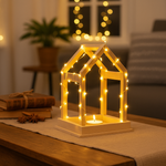 MDF lantern with string lights on a table in a cozy room setting.