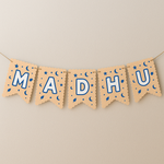 Banner with the name 'MADHU' on a beige background