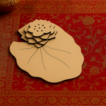 Plain MDF lotus incense holder on red patterned background.