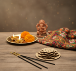 Decorative pooja setup with round MDF flower-shaped incense holder and marigold flowers.