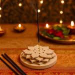 MDF flower incense holder on festive table with burning incense