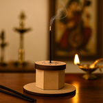 MDF round incense stick holder with two burning incense sticks, festive background.