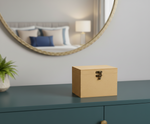 jewellery box on a dresser with a mirror and pillows in the background