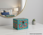Decorative jewellery box with intricate patterns on a white surface