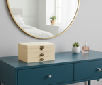 MDF DIY Jewellery Box on a blue dresser with a mirror and plant in the background
