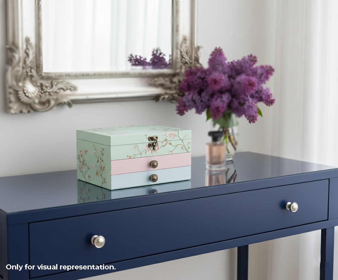 Decorative  jewellery MDF DIY box on a navy blue console table with a vase of purple flowers.