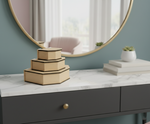 Decorative hexagonal MDF DIY Jewellery boxes on a marble surface with a round mirror in the background.