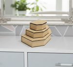 Set of three hexagonal  MDF DIY  jewellery boxes on a white surface with a blurred background