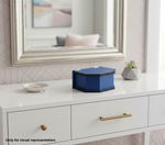Blue hexagonal MDF DIY jewellery box on a white dresser with a mirror and decor in the background