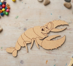 MDF DIY  lobster toy on a wooden surface with colorful beads and stones.