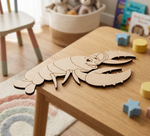 MDF DIY  lobster puzzle on a child's table with toys in the background