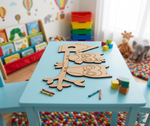 Children's playroom with a blue table featuring MDF DIY  animal cutouts and colorful toys.