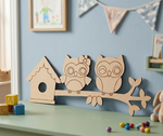 MDF DIY  owl and birdhouse decoration on a shelf with colorful balls and toys.