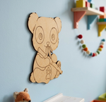 MDF DIY  bear wall decoration on a light blue wall with colorful children's toys in the background.