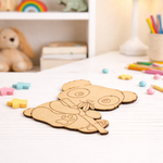 MDF DIY  bear cutout on a table with colorful crayons and toys in the background