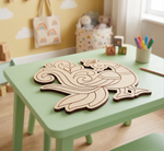 MDF DIY peacock cutout on a green table with colorful markers and toys in the background