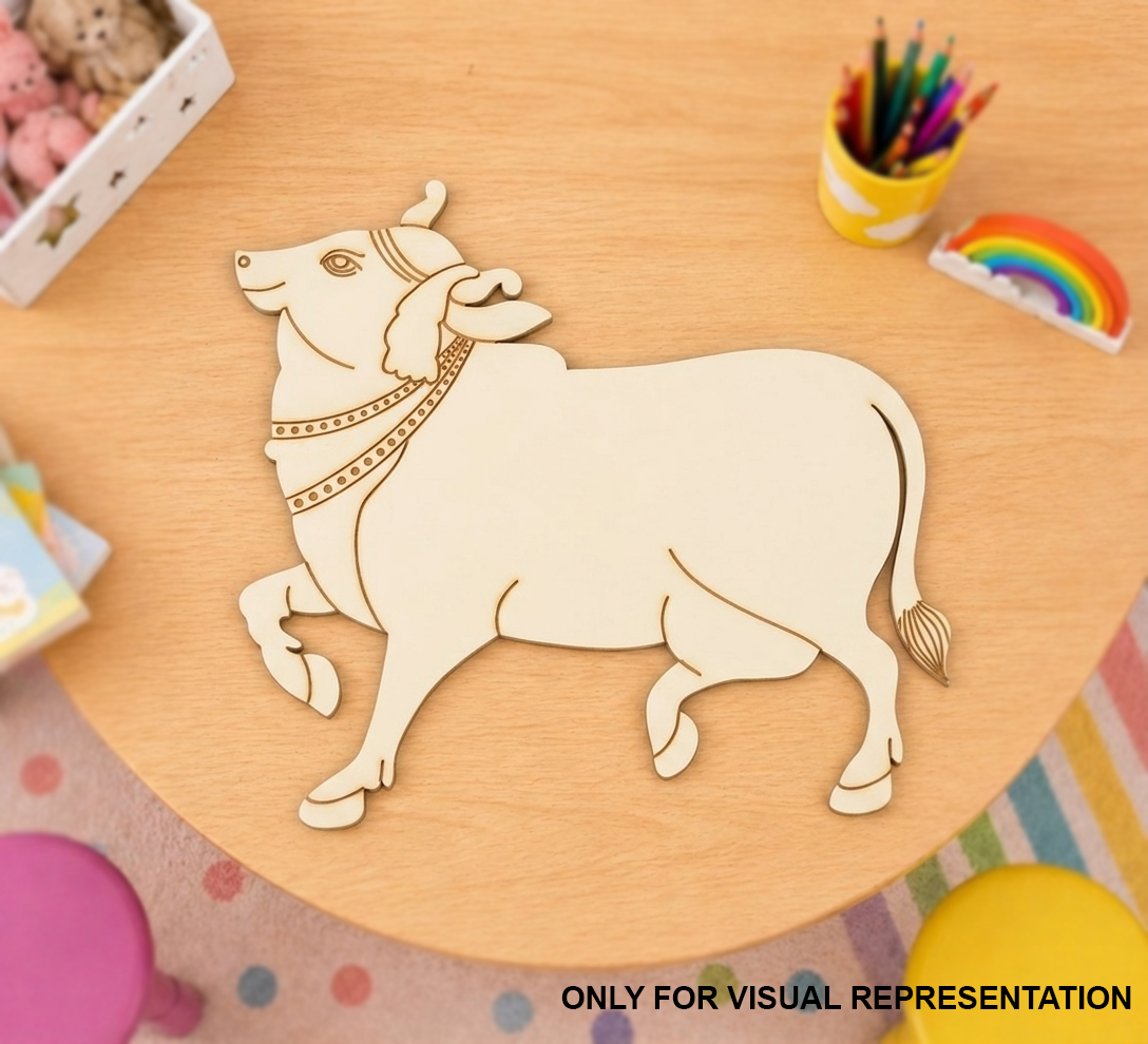 MDF DIY bull cutout on a wooden table with stationery items.
