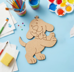 MDF DIY dog cutout on a blue table with art supplies