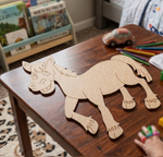 MDF DIY donkey cutout on a wooden table with coloring supplies and books in the background.