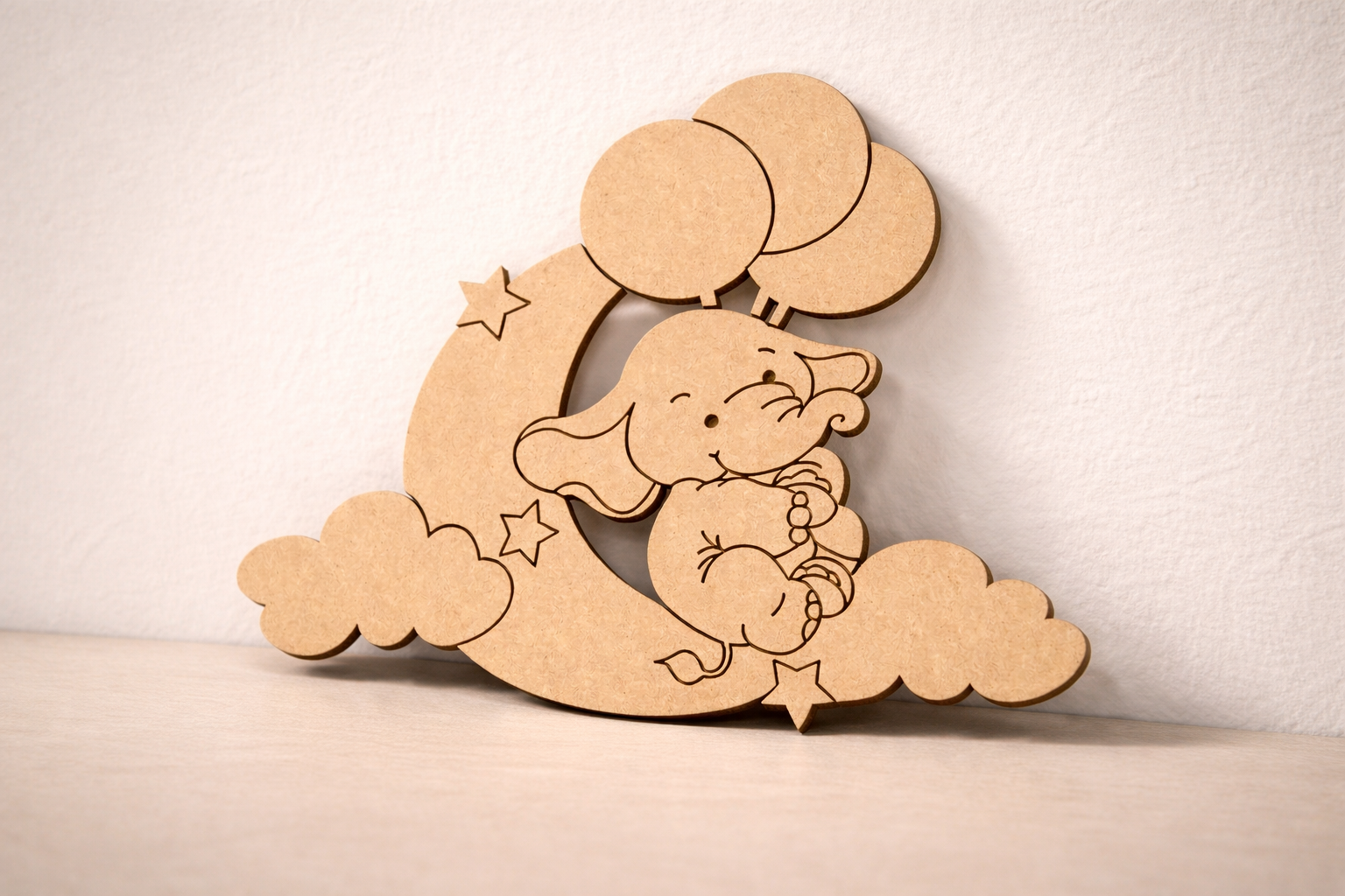 MDF DIY cutout of a baby elephant with balloons on a cloud against a white background