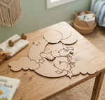 MDF DIY elephant cutout on a wooden table with a child's book and toys in the background.