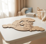 MDF DIY elephant cutout on a white table with soft toys and a basket in the background