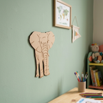 MDF DIY elephant wall decoration on a light green wall with books and a teddy bear in the background.