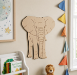 MDF DIY elephant cutout on a wall in a child's room with books and a teddy bear.