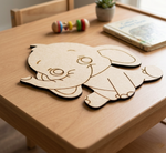 MDF DIYelephant cutout on a wooden table with toys and a book in the background