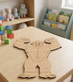 MDF DIY cutout with a gorilla design on a table surrounded by colorful blocks and books.