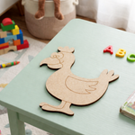 MDF DIY chicken cutout on a child's table with colorful letters and toys in the background